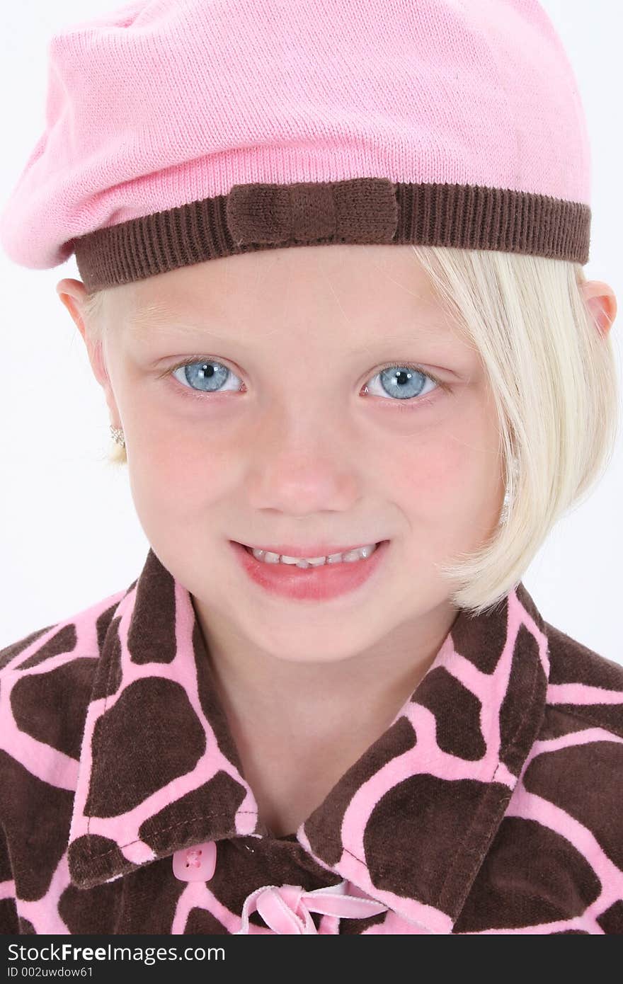 Adorable girl in pink barret with blonde hair and big blue eyes.