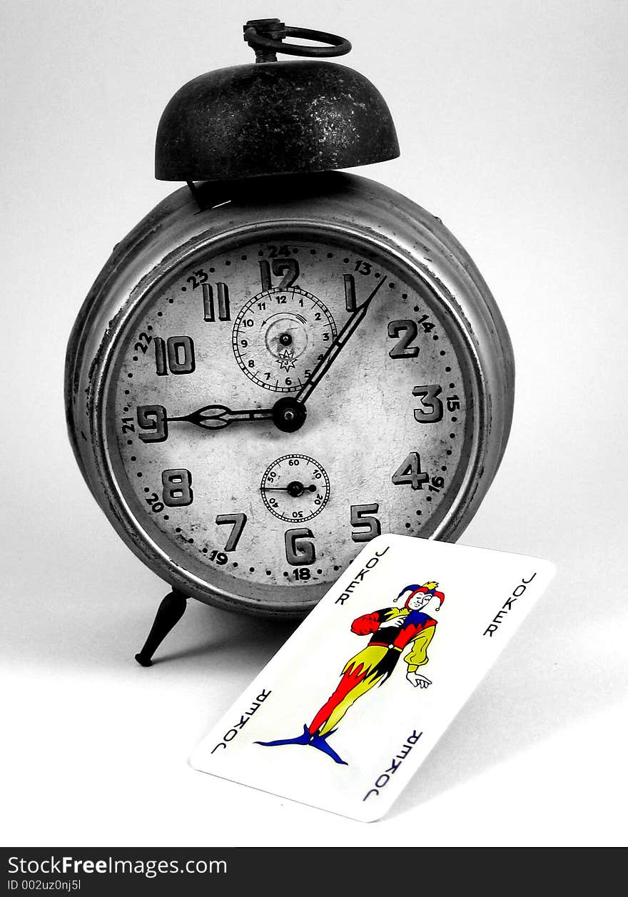 Old Clock And A Joker Card