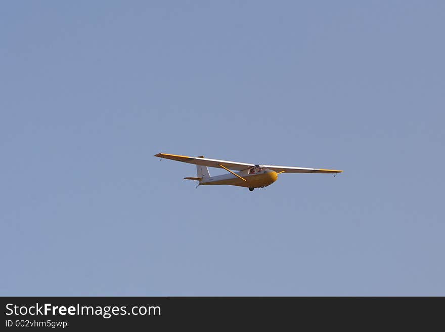 Yellow glider in blue sky