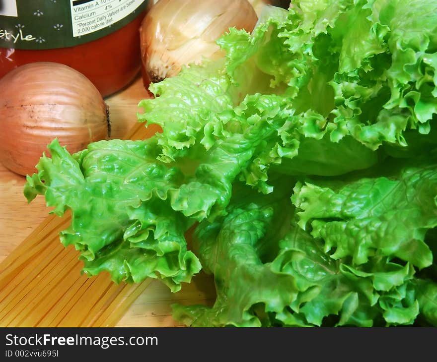 Close-up lettuce and onions with pasta