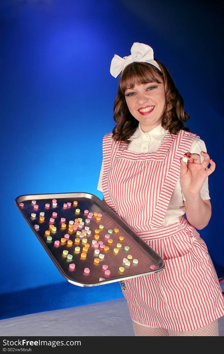 Teenage candy stripper passes out hearts on a silver tray