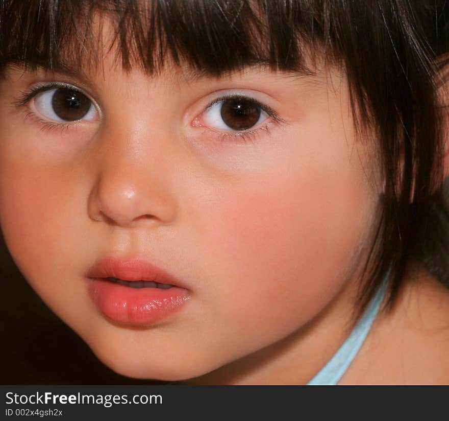 Face of a little girl with rosebud shaped lips and large brown eyes. Face of a little girl with rosebud shaped lips and large brown eyes.