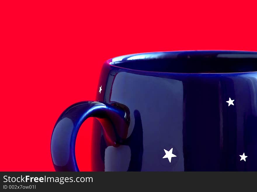 Blue coffee cup with stars on a red background