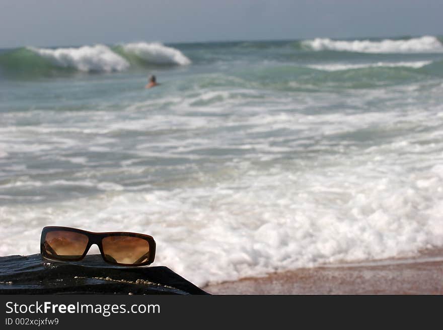 Sunglasses On A Rock Near Waves