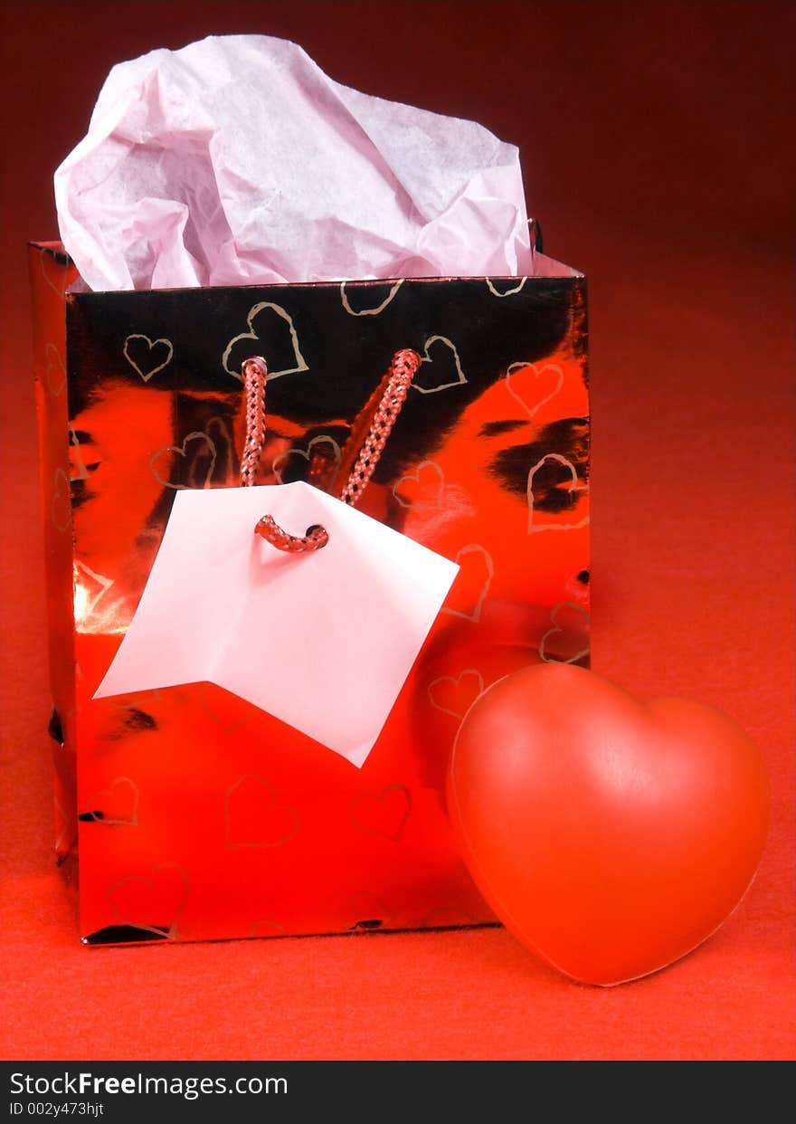 Isolated over red felt gift bag and hearts. Isolated over red felt gift bag and hearts