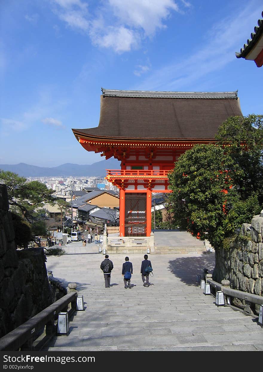 Three school boys walking down a flight of stairs out of a temple. Three school boys walking down a flight of stairs out of a temple