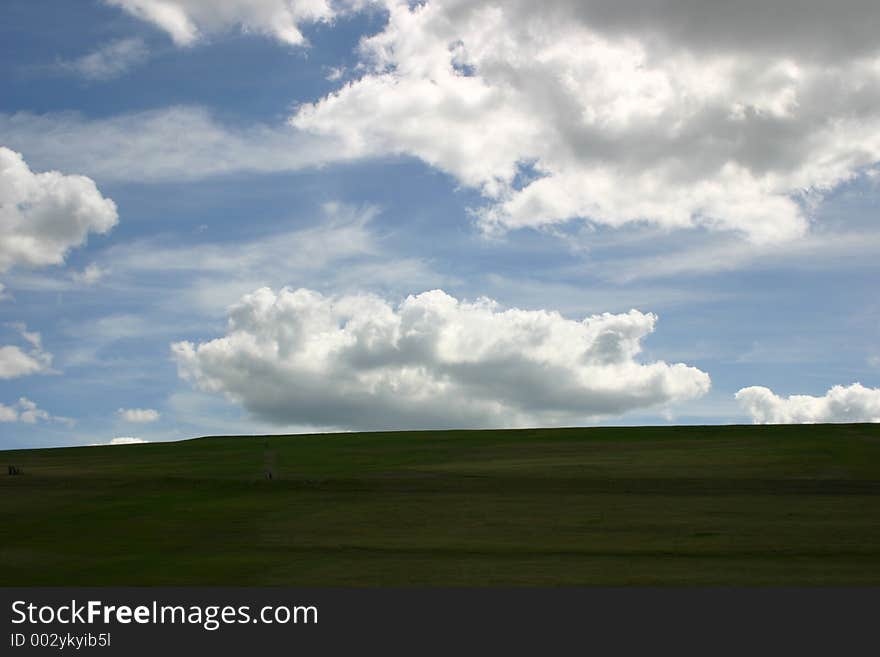 Beautiful field and blue cloudy sky. Beautiful field and blue cloudy sky.