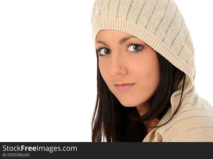 Beautiful young woman in hooded sweater over white. Shot in studio.