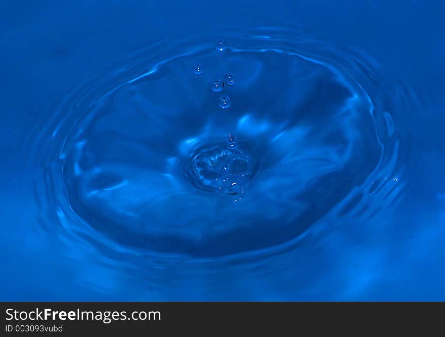 Water drop captured on impact with the still water surface