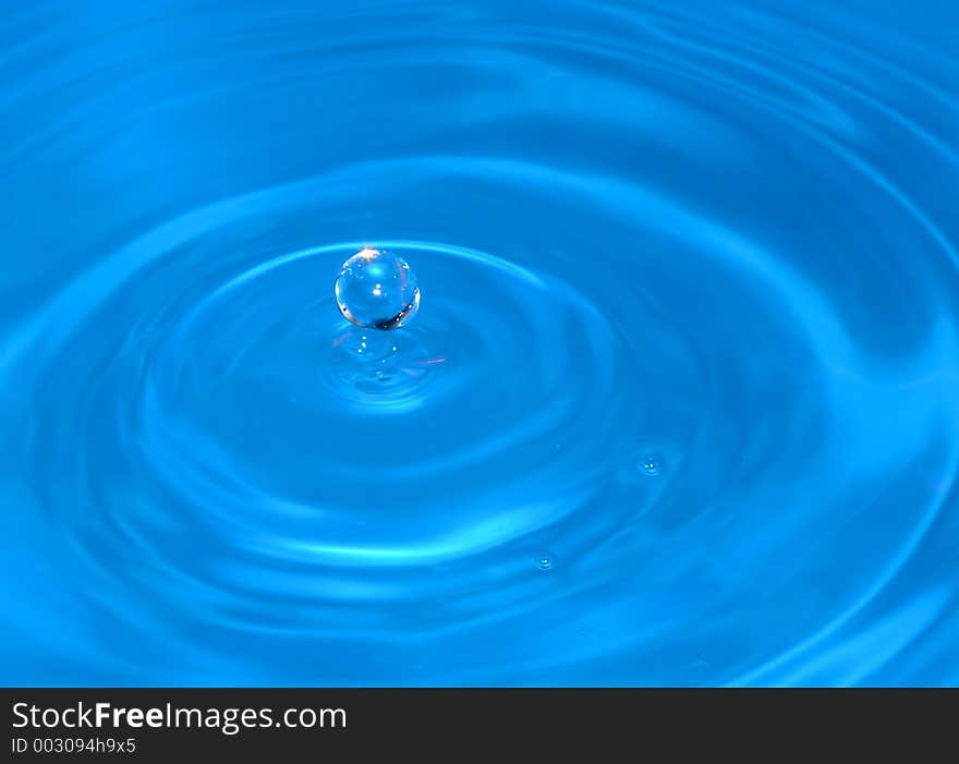 Water drop captured on impact with the still water surface