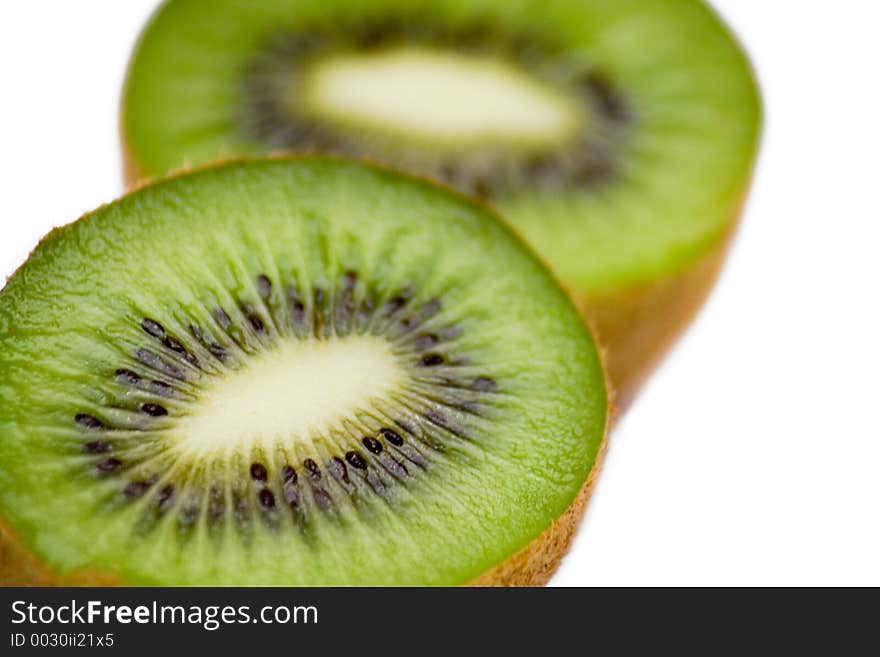 Close up on a sliced kiwi fruit on a white background. Close up on a sliced kiwi fruit on a white background.