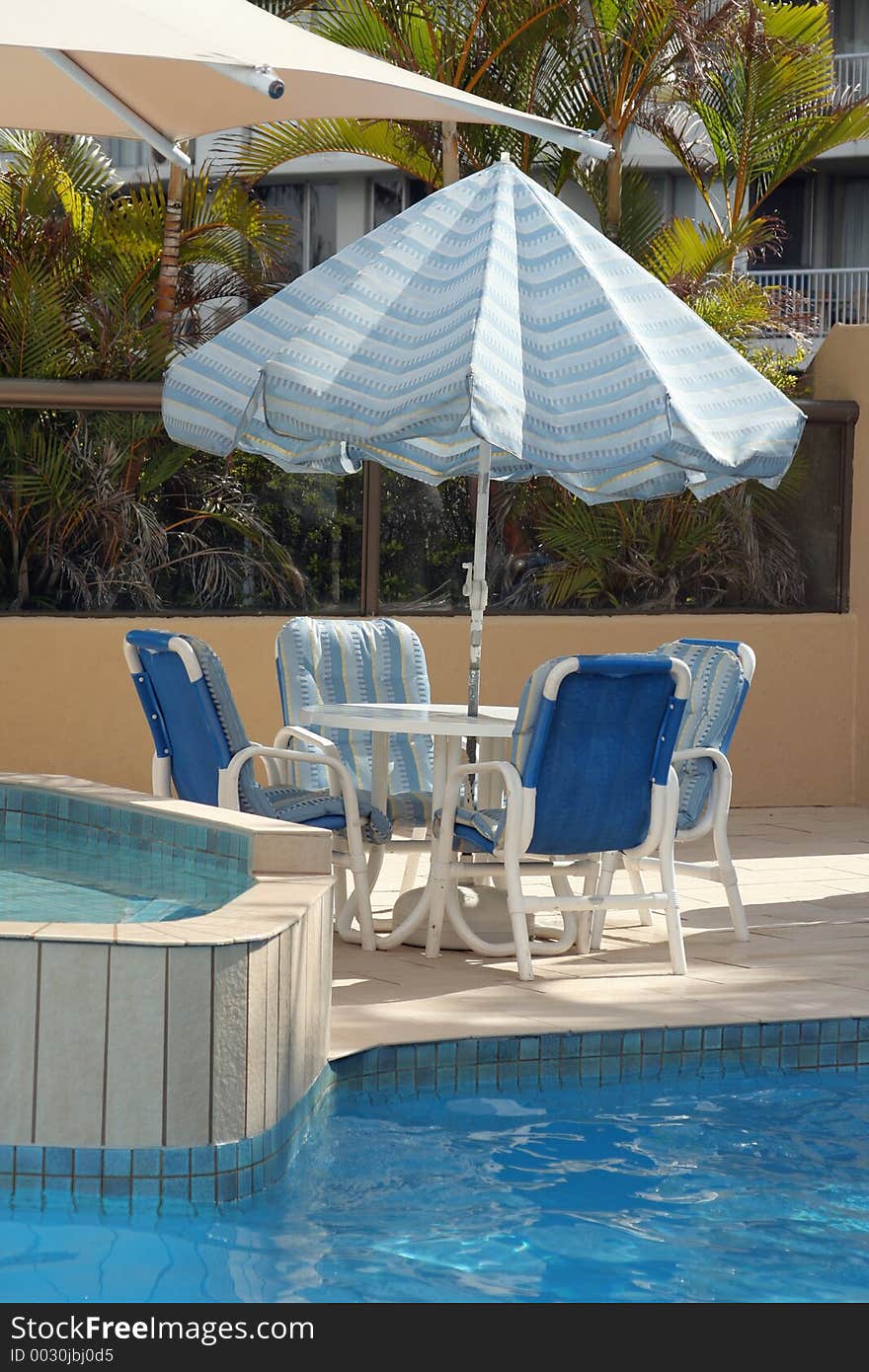 Blue chairs and sunshade by the pool. Blue chairs and sunshade by the pool