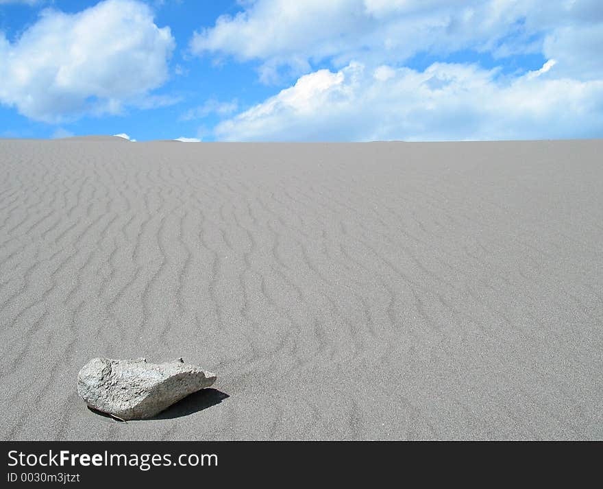 Stone alone in the sand. Stone alone in the sand.