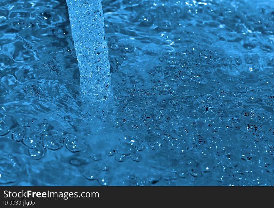 Water flow captured on impact with the still water surface