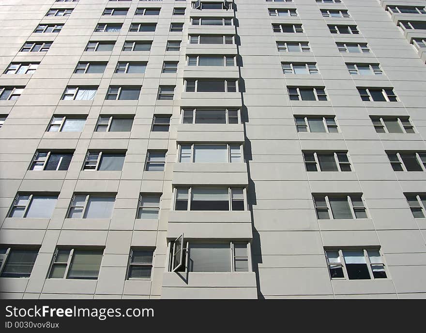 The view looking up the side of a city apartment building. The view looking up the side of a city apartment building.