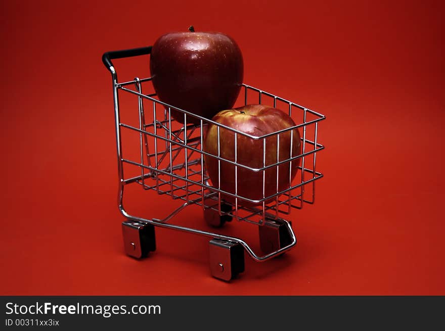 Juicy red apples stacked in a shopping cart. Juicy red apples stacked in a shopping cart.