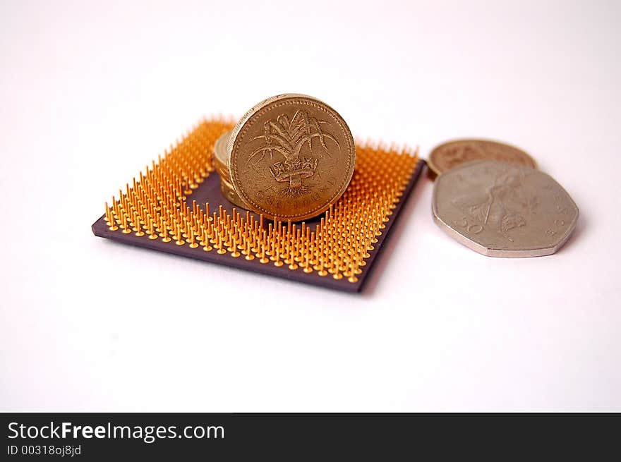 This is an image of a microprocessor and pound coins. This is an image of a microprocessor and pound coins.