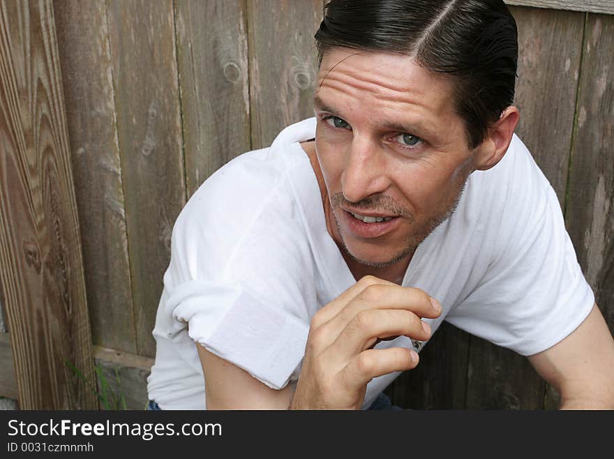 A man caught smoking a cigarette.