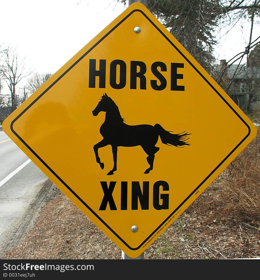 Horse crossing sign on a rural road. Horse crossing sign on a rural road.