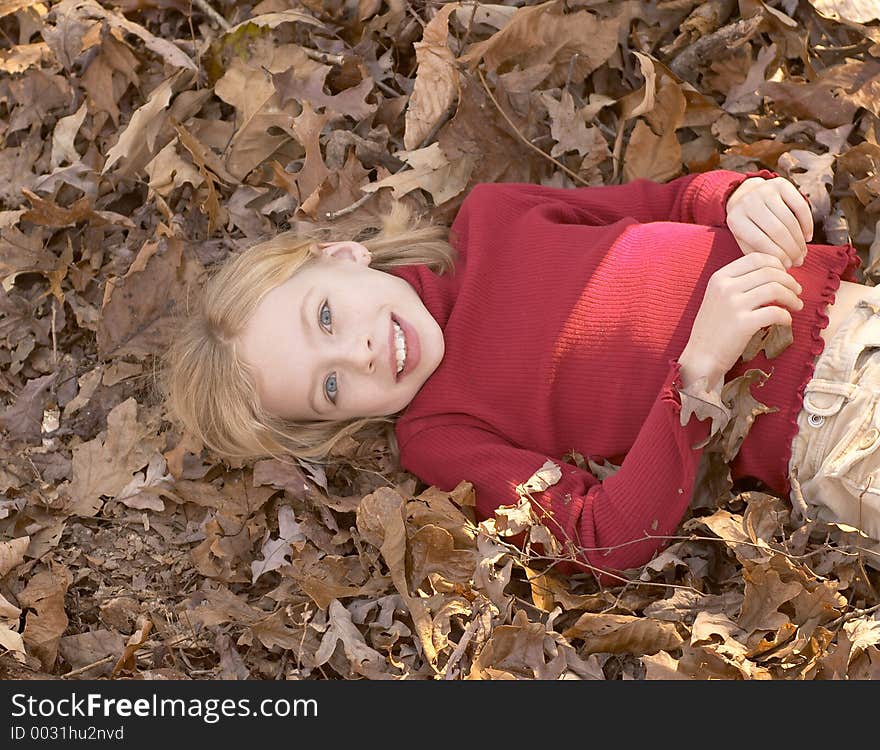 Girl laying in leaves. Girl laying in leaves