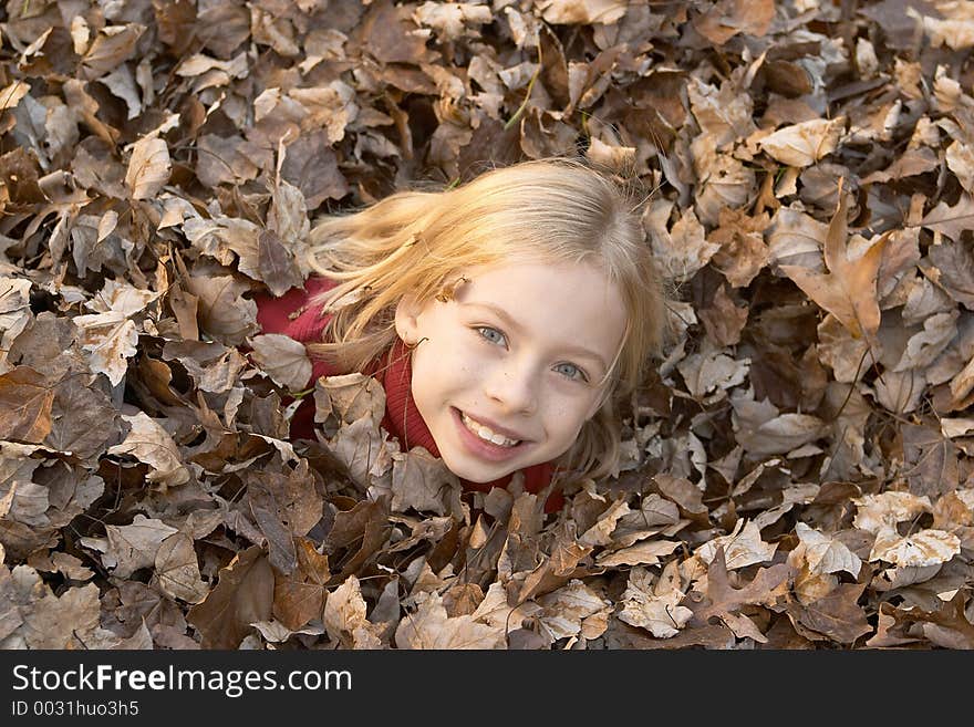 Girl playing in leaves. Girl playing in leaves