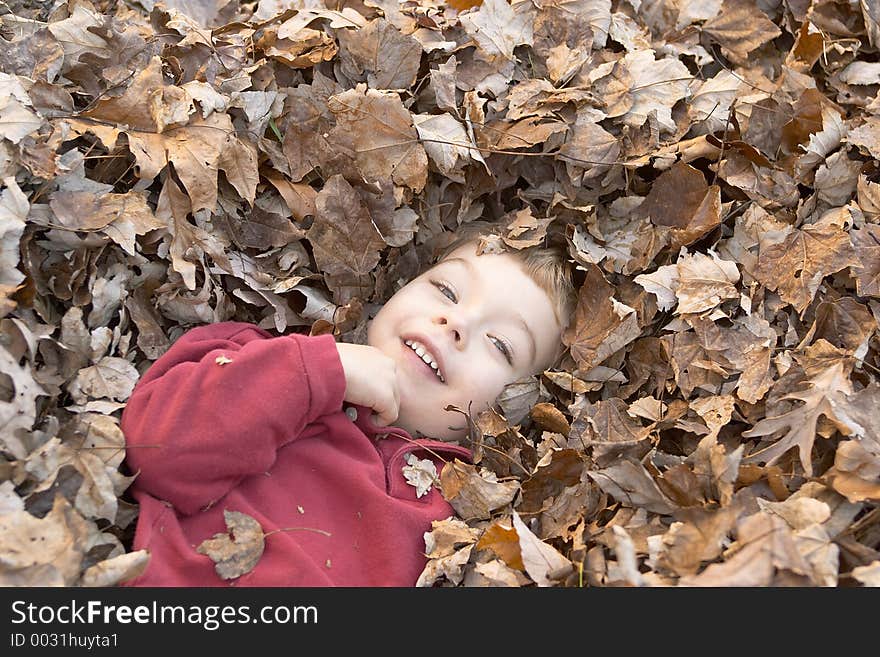 Boy in leaves