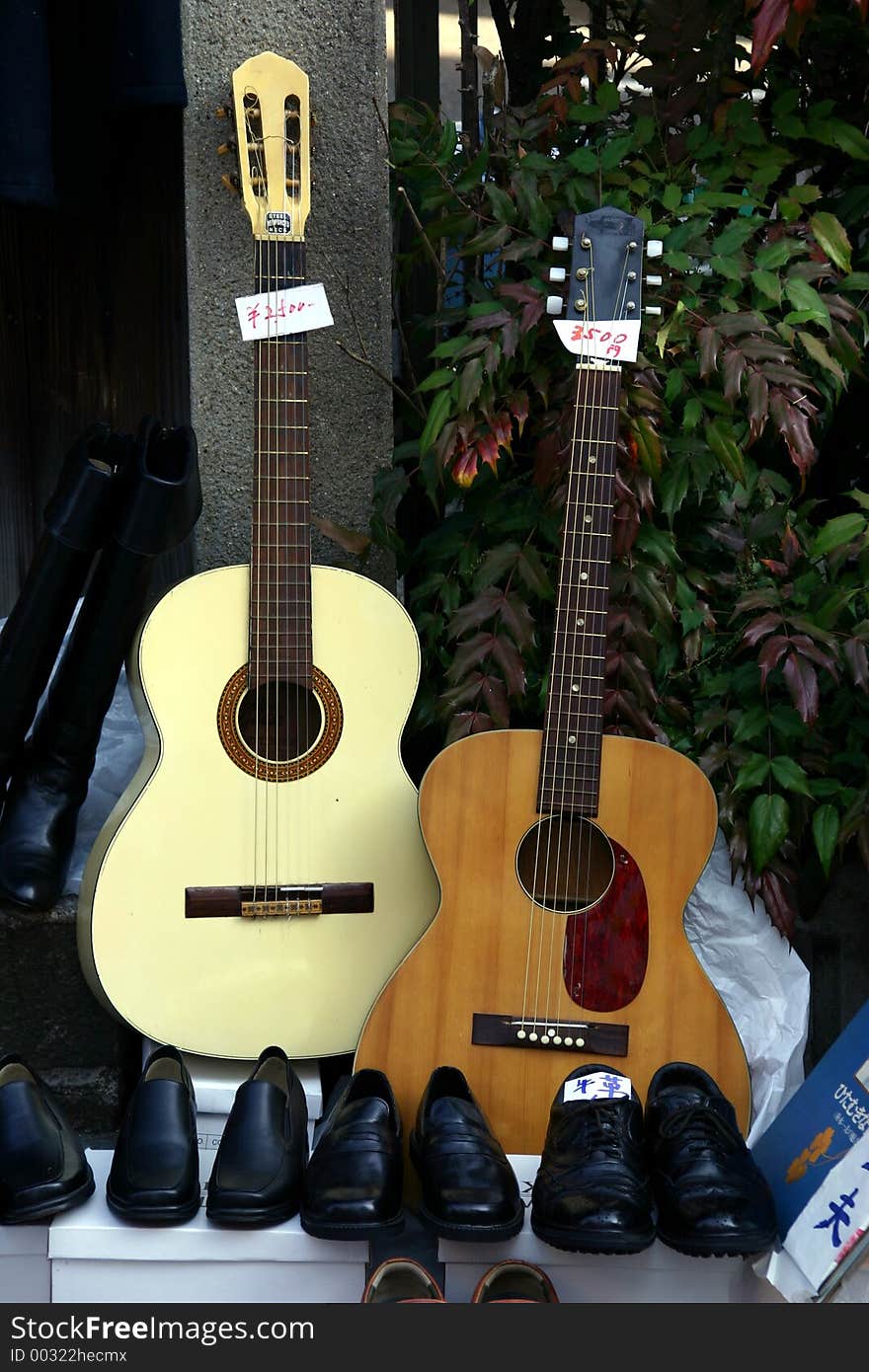 Two guitars and some shoes pairs for sale