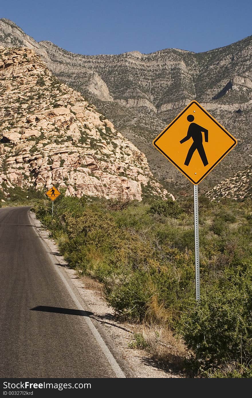 Pedestrian crossing caution sign on a western roadway. Pedestrian crossing caution sign on a western roadway