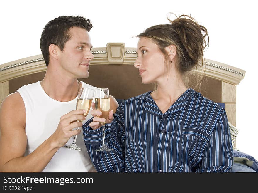 Newly weds toasting on the conjugal bed. Newly weds toasting on the conjugal bed.