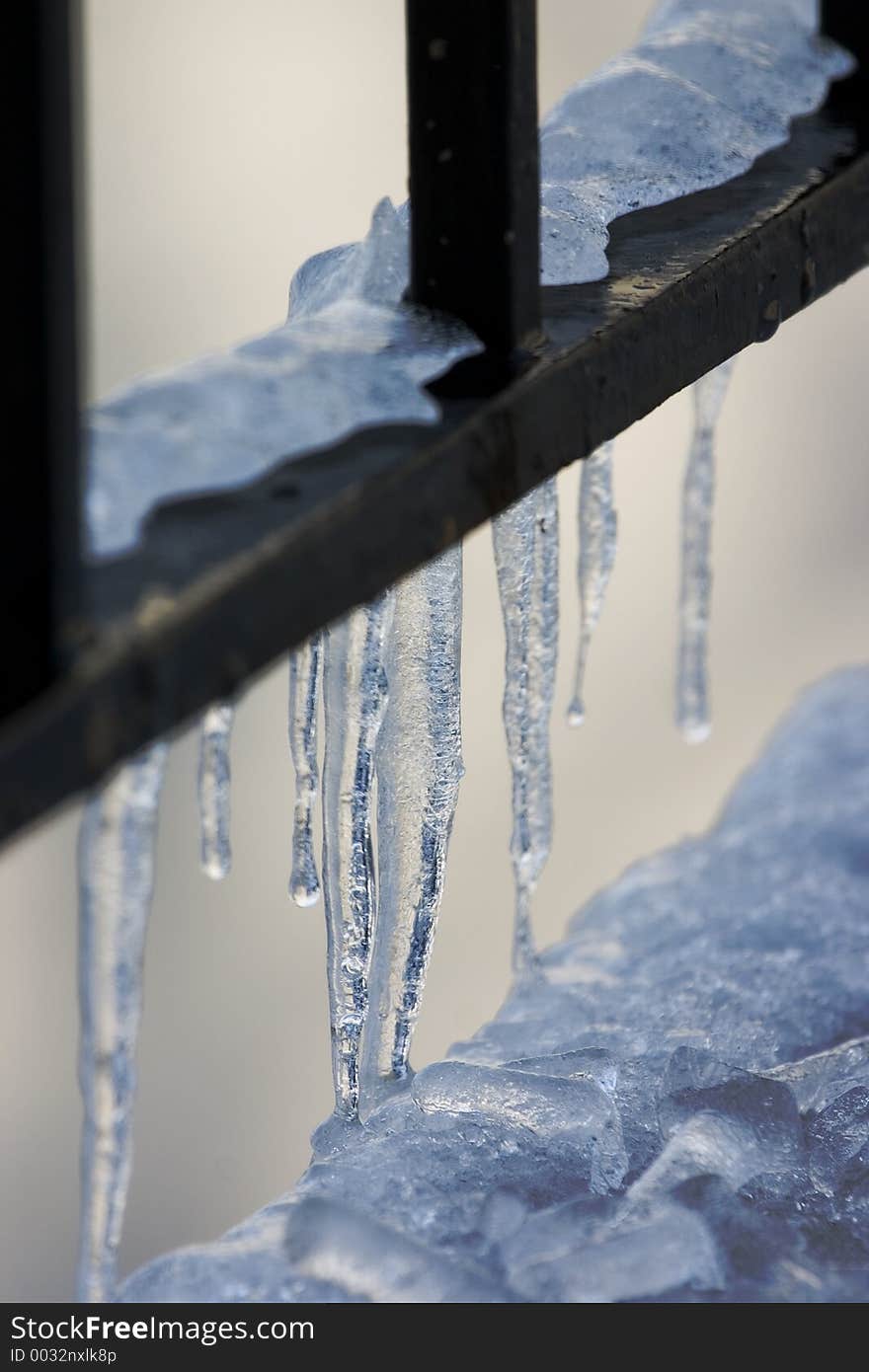 Icicles on a metal railing. Icicles on a metal railing