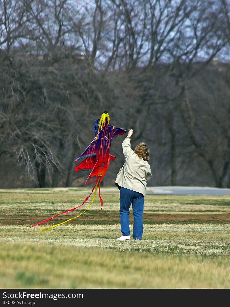 Mom helping children fly kite. Mom helping children fly kite