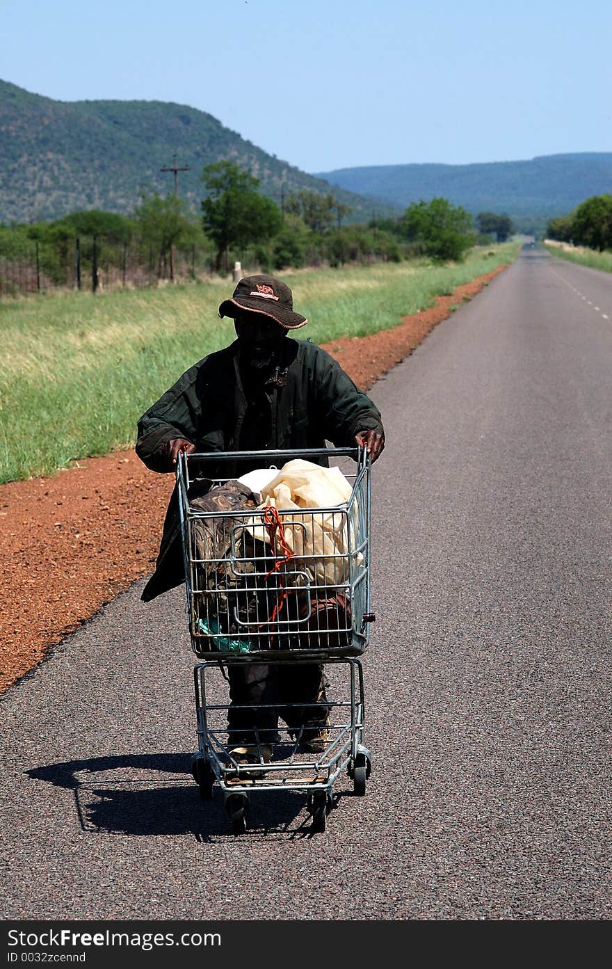 Man with shopping cart 50km from closest town. Man with shopping cart 50km from closest town