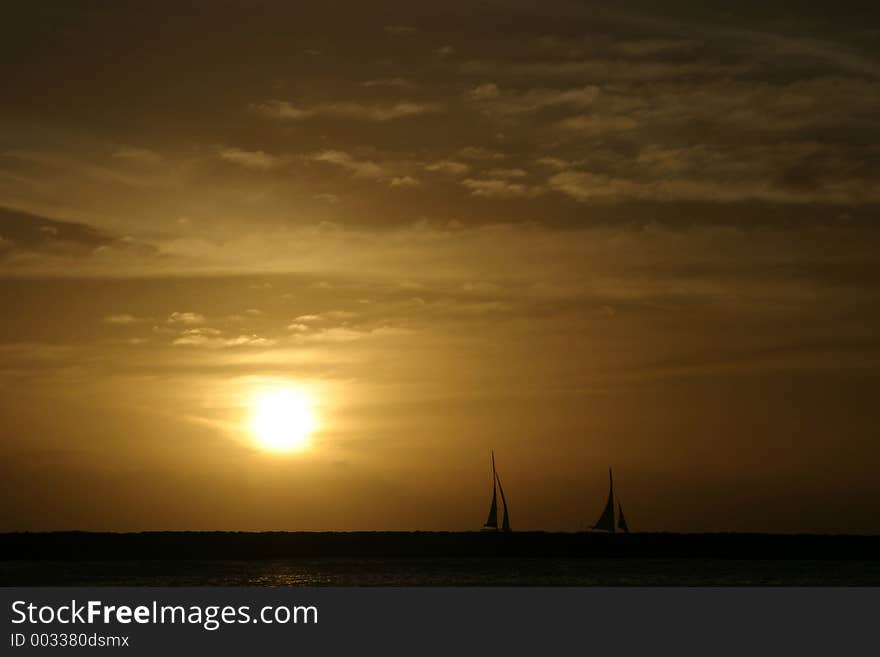 Silhouetted Sailboats at sunset