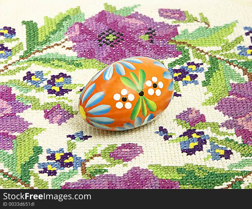 Traditional painted Easter egg over knitted tablecloth. Traditional painted Easter egg over knitted tablecloth