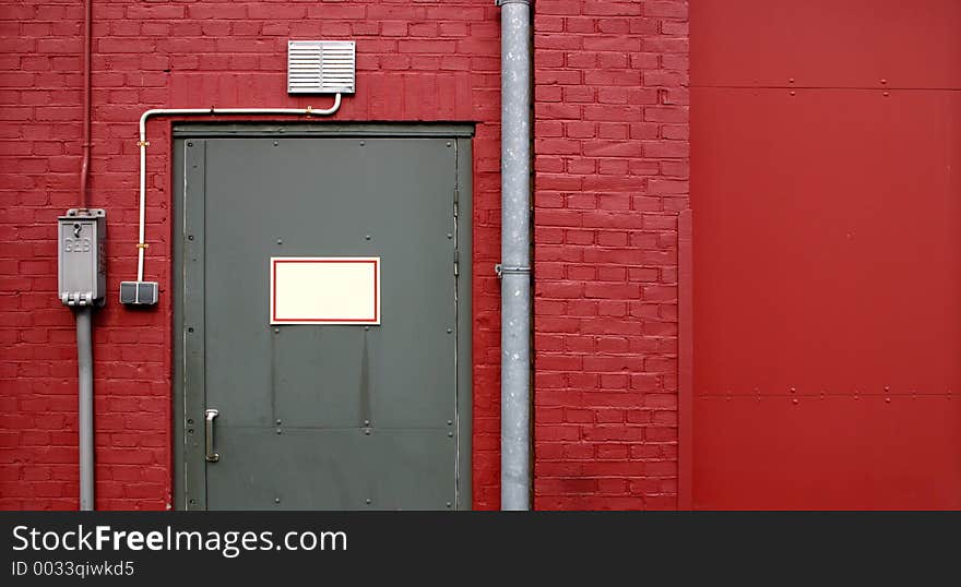 Grey door on red wall, Amsterdam