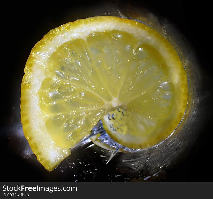 Lemon in a glass with soda-water. Lemon in a glass with soda-water