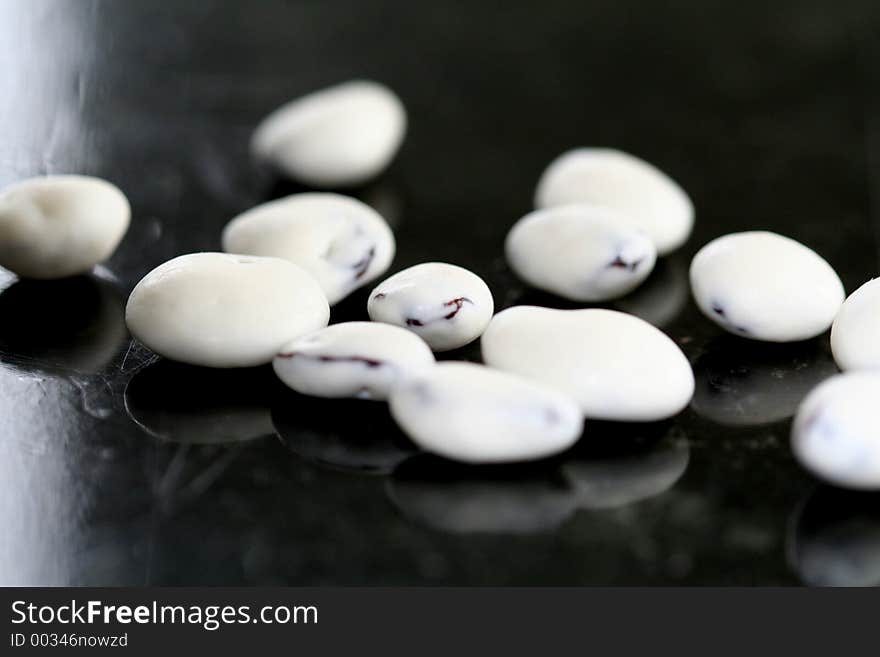 Closeup of yogurt covered raisins on black marble