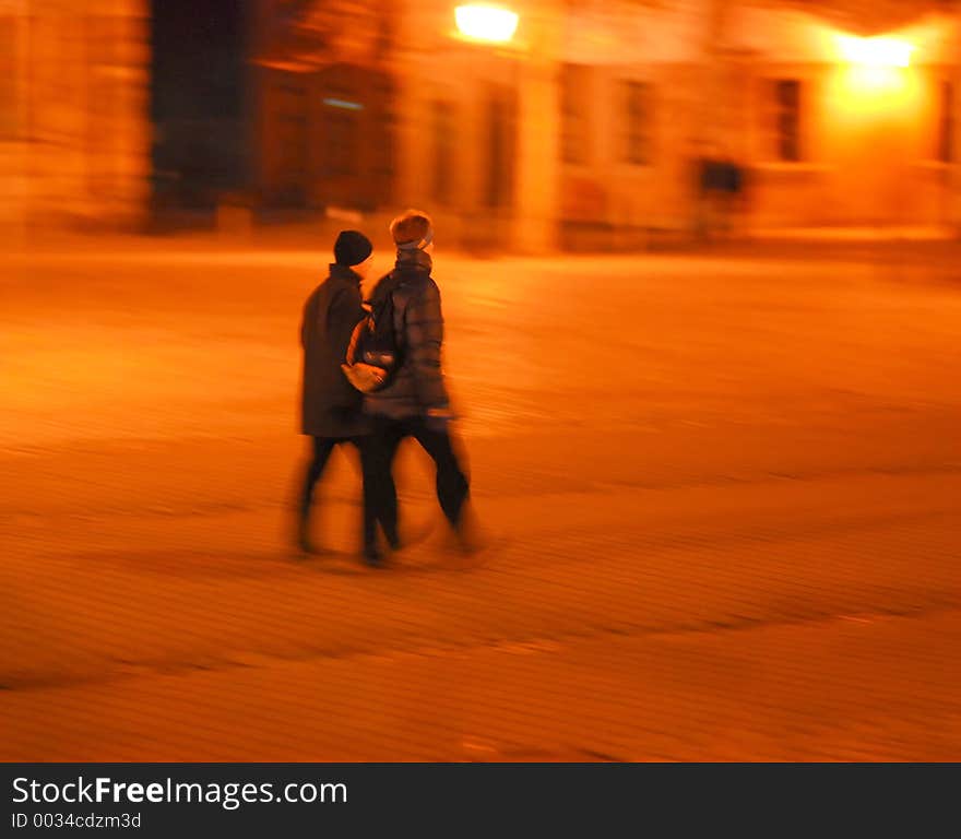 Dynamic night scene, Persons' heads are focused, rest shows motion blur. Dynamic night scene, Persons' heads are focused, rest shows motion blur