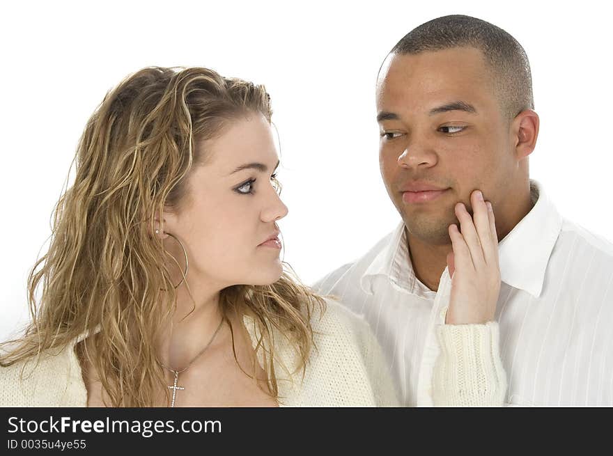 Young couple looking at each other. Headshot over white.