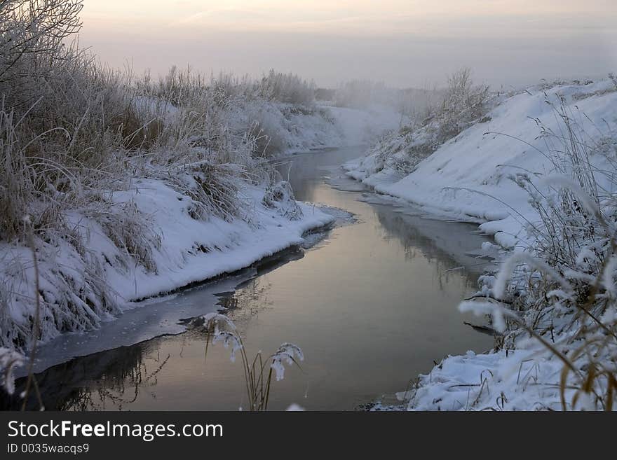 Steamy river (air -26C) in dim dawn light. Steamy river (air -26C) in dim dawn light