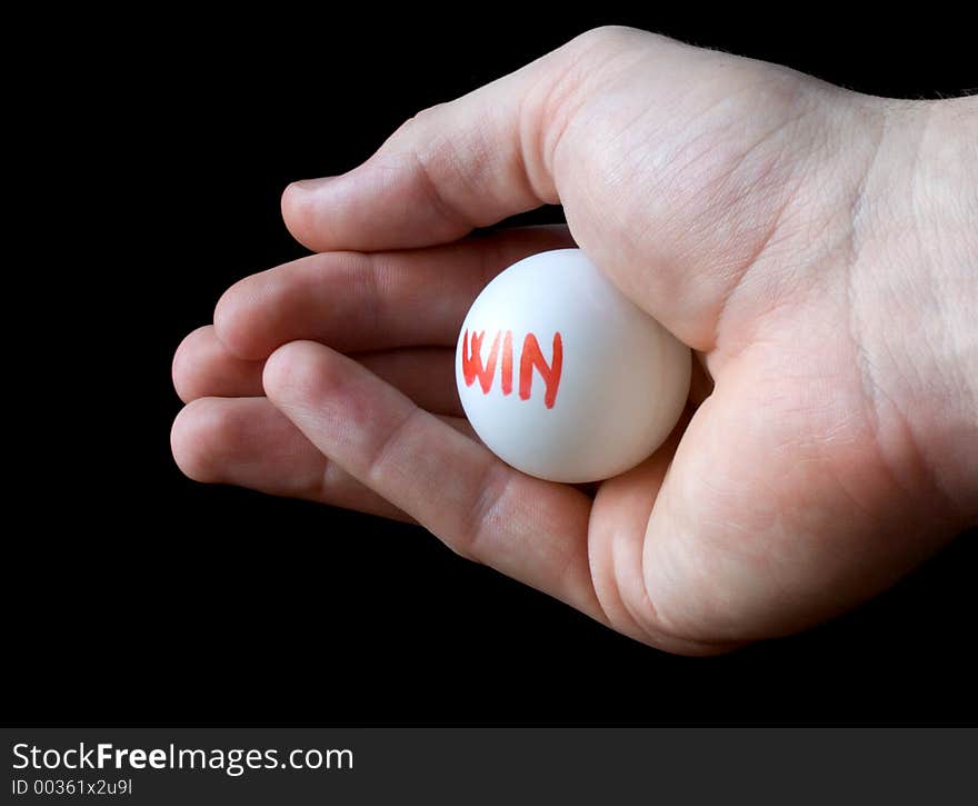 Hand holding lottery ball. Isolated on black. Blank winner lottery ball. Choose win ball. Lucky winning concept. Word win. Hand holding lottery ball. Isolated on black. Blank winner lottery ball. Choose win ball. Lucky winning concept. Word win