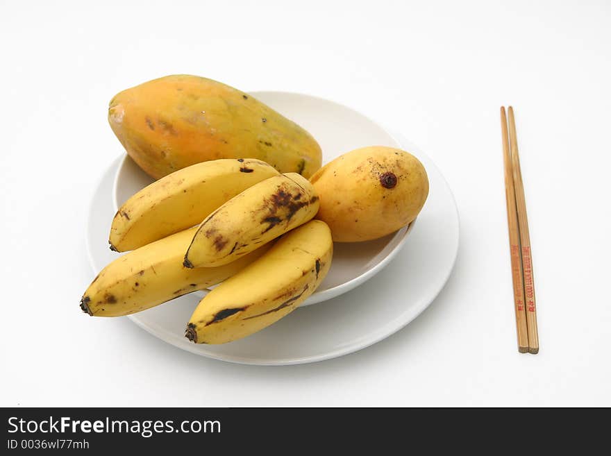 Tropical fruit served on white ceramics. Tropical fruit served on white ceramics