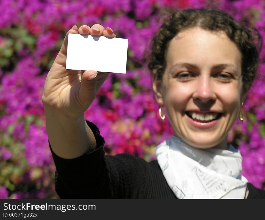 Girl with card for text and flowers