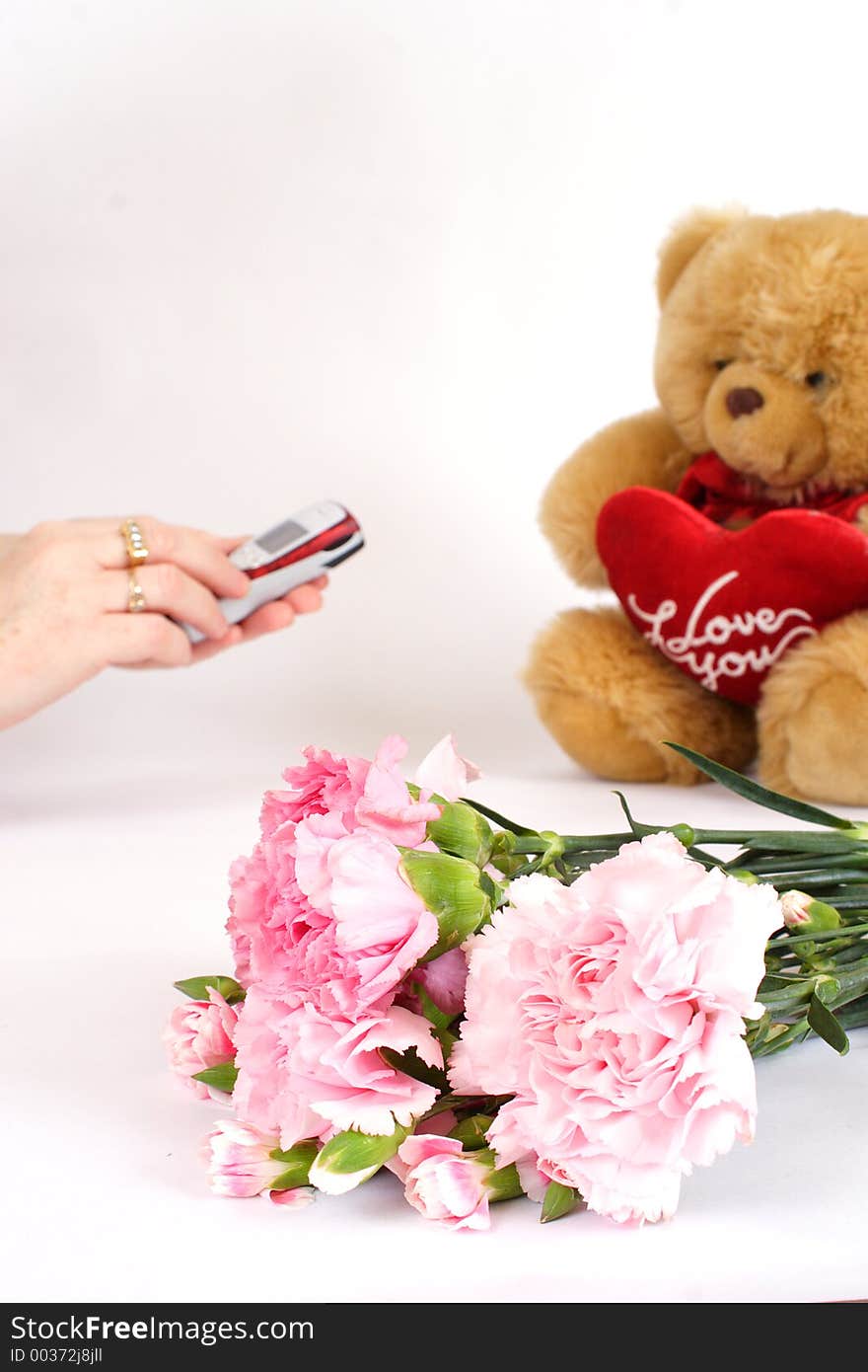 Womans hands dialling phone with gifts to the side. Ideal for valentines day or anniversaries, dating etc. Womans hands dialling phone with gifts to the side. Ideal for valentines day or anniversaries, dating etc