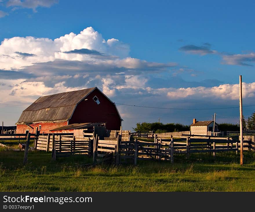 Evening light descends on a farm yard on the prairies. Evening light descends on a farm yard on the prairies.