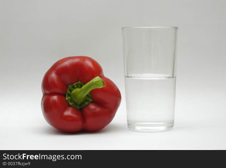 Red paprika and a glass of water. Red paprika and a glass of water.