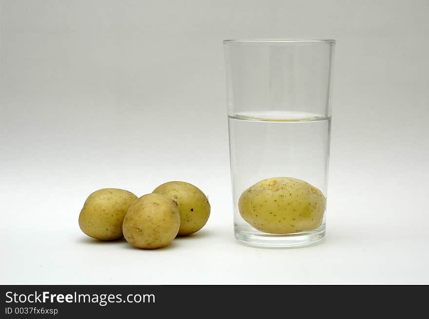 Potatoes and a glass of water. Potatoes and a glass of water.