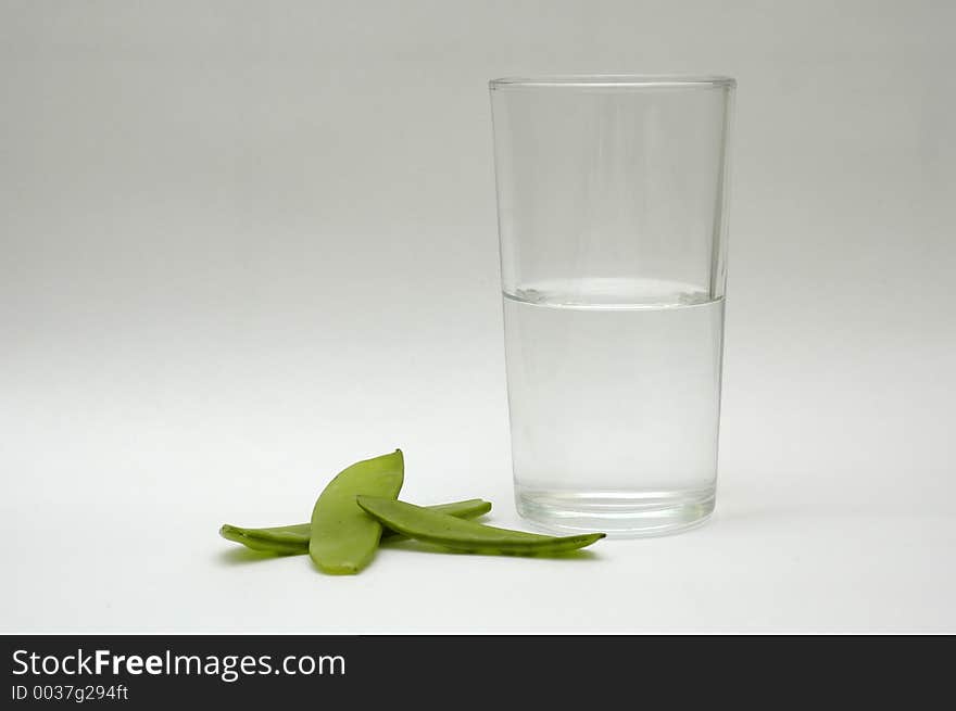 Green vegetable and a glass of water. Green vegetable and a glass of water.