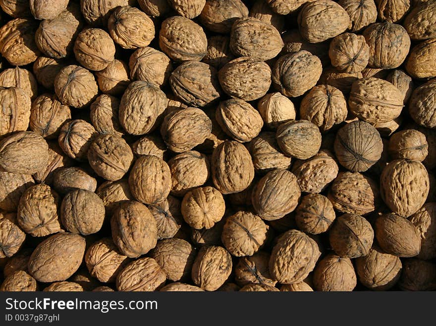 High-res image of many walnuts in a market stand