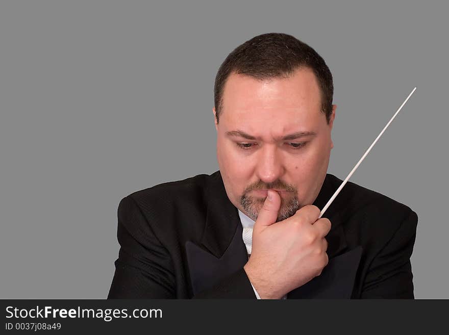 An orchestra conductor, isolated against a white background, studies a score, deep in thought. An orchestra conductor, isolated against a white background, studies a score, deep in thought.